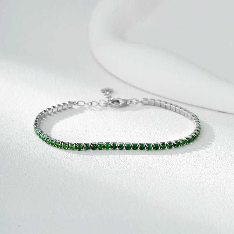 Delicate silver bracelet with small vibrant green gemstones, elegant natural jewelry piece