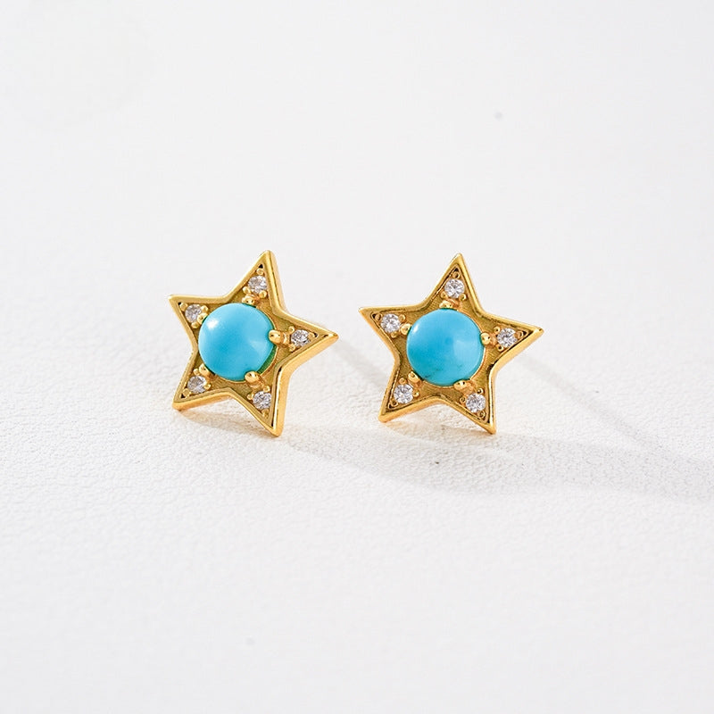Gold plated star-shaped earrings with central turquoise gemstones and small clear crystals